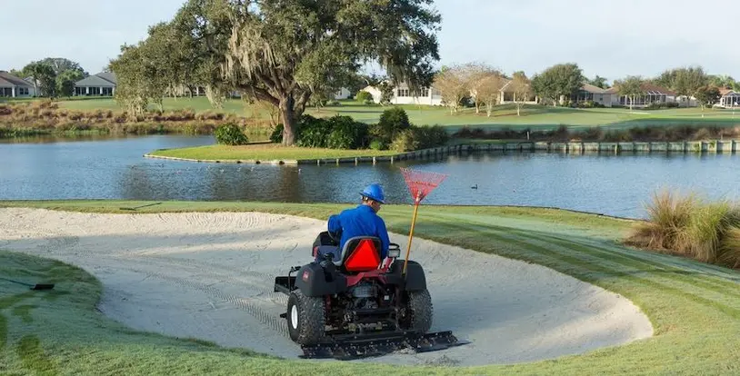 crew member operating bunker rake safely